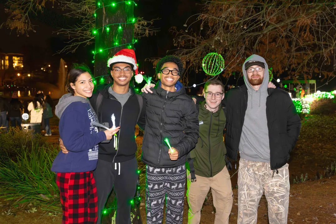 Students smiling at night for Light Up The Lake